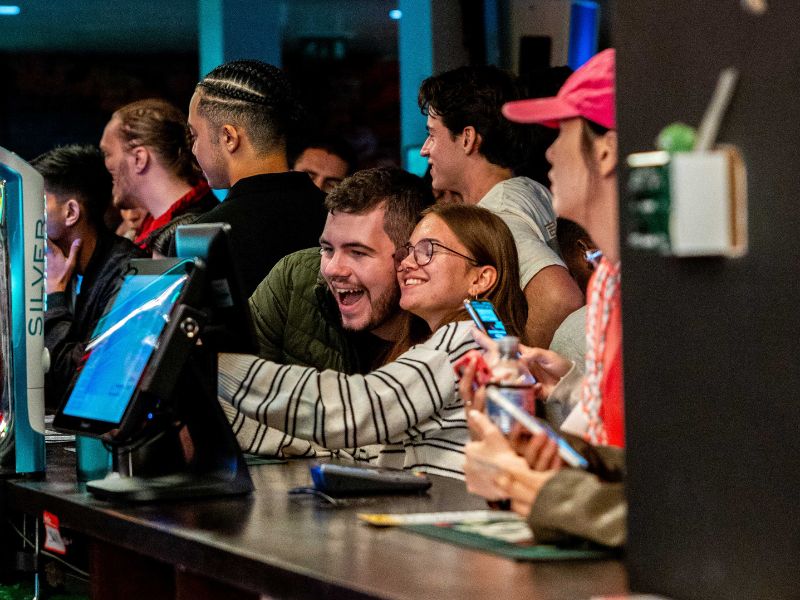 2 Essex Students hug at a bar